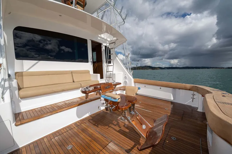 Slide: The Image of 2007 Viking 64 Convertible yacht deck with seating and fishing chair on open water. - 34