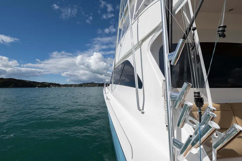 Slide: The Image of 2007 Viking 64 Convertible yacht on calm waters under a clear blue sky. - 39