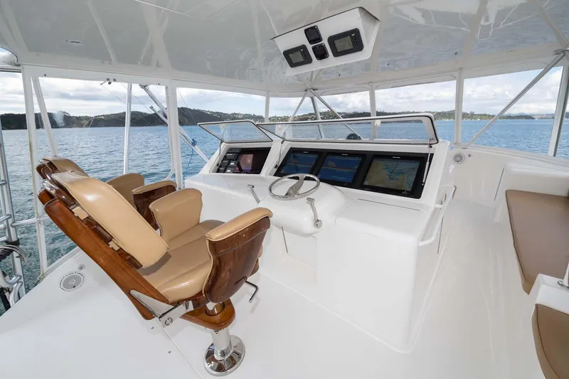 Slide: The Image of 2007 Viking 64 Convertible yacht helm with leather seats and navigation screens. - 45