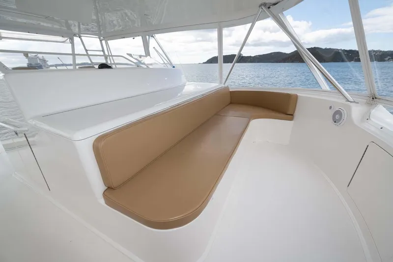 Slide: The Image of Luxurious seating area on a 2007 Viking 64 Convertible yacht, overlooking serene waters. - 46