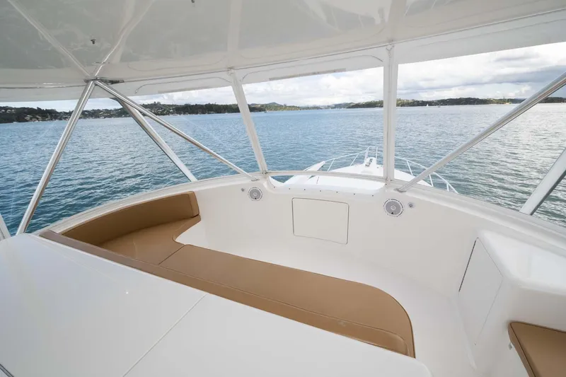 Slide: The Image of 2007 Viking 64 Convertible yacht with spacious seating overlooking serene waters. - 48