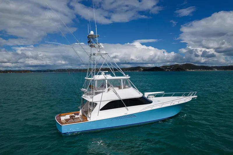 Slide: The Image of 2007 Viking 64 Convertible yacht on blue ocean under cloudy sky. - 5