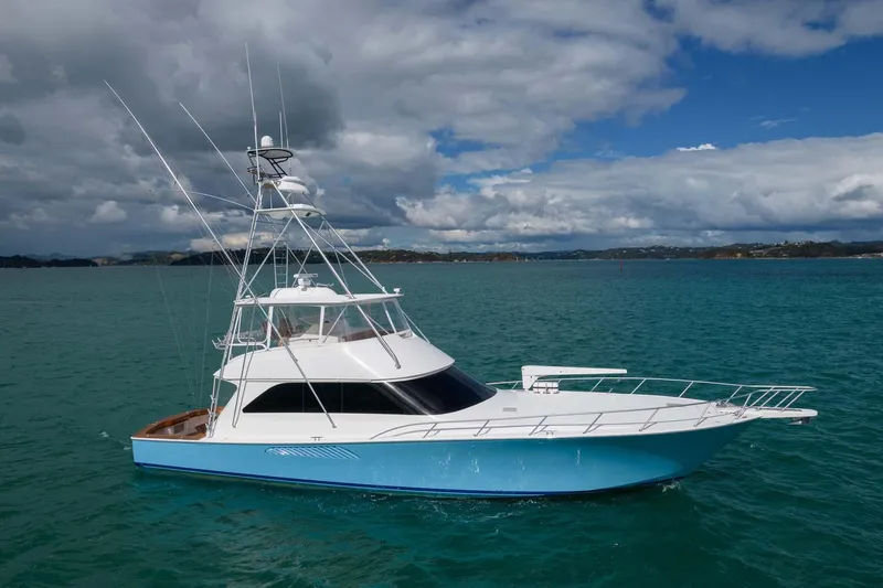 Slide: The Image of 2007 Viking 64 Convertible yacht on turquoise water under cloudy sky. - 6