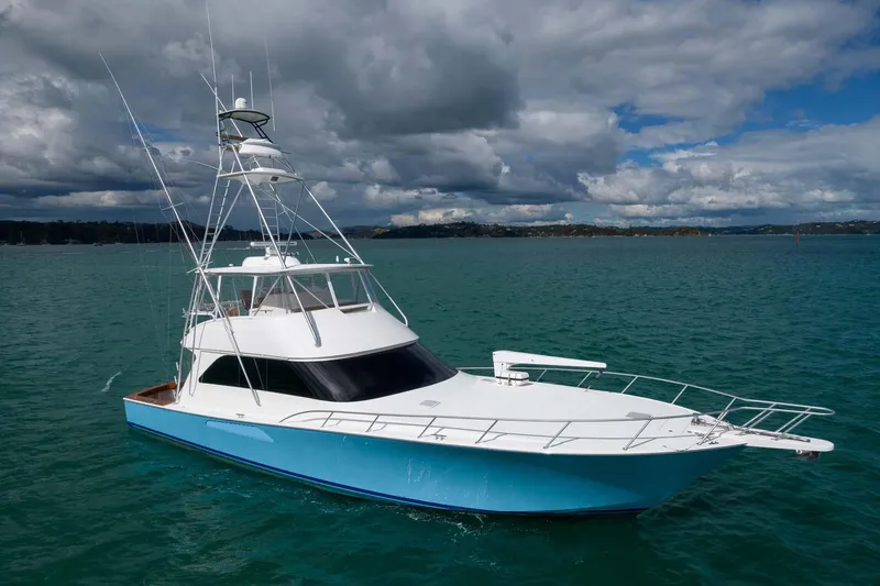 Slide: The Image of 2007 Viking 64 Convertible yacht on turquoise water under cloudy sky. - 7