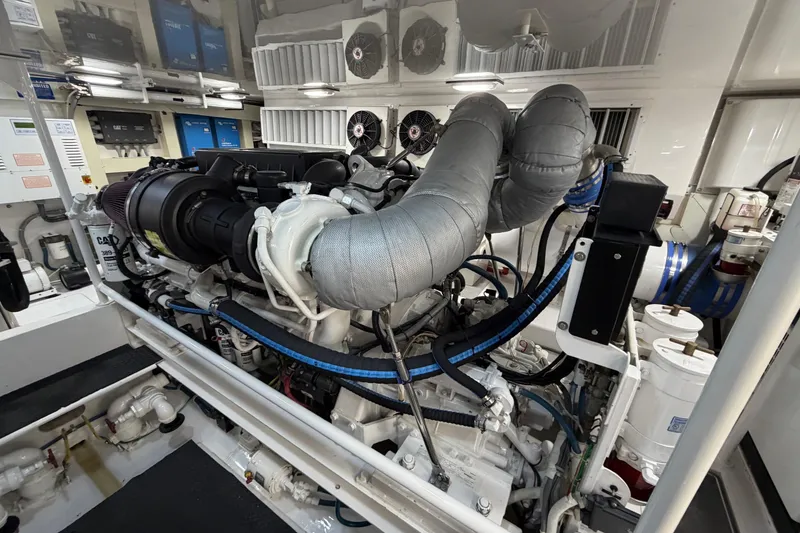 Slide: The Image of Engine room of a 2007 Viking 64 Convertible yacht, showcasing detailed machinery and components. - 84