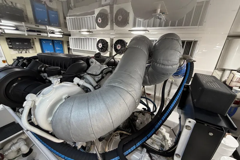 Slide: The Image of Engine room of 2007 Viking 64 Convertible yacht, featuring dual engines and control panels. - 91