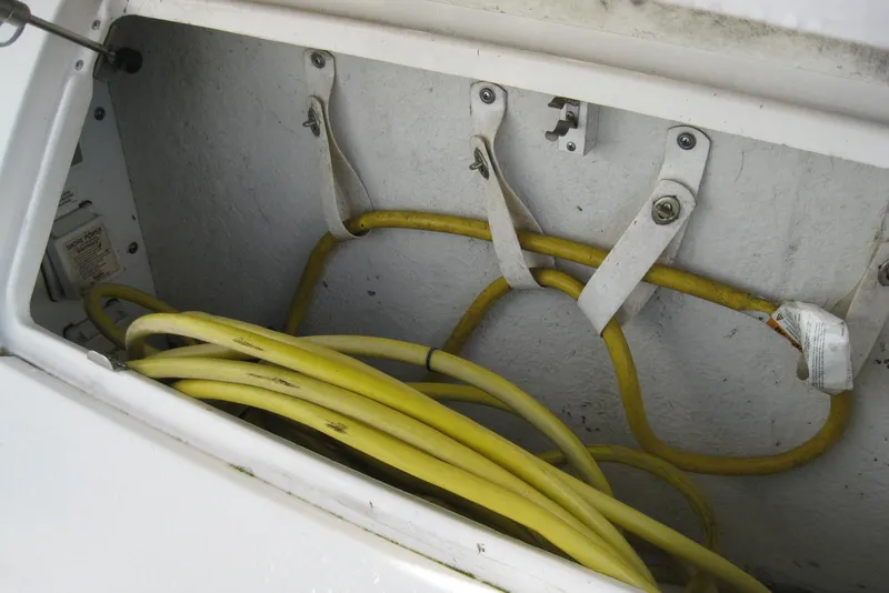 Slide: The Image of 2002 Sea Ray Sundancer 280 boat with Mercury outdrive and propeller, parked on pavement. - 11