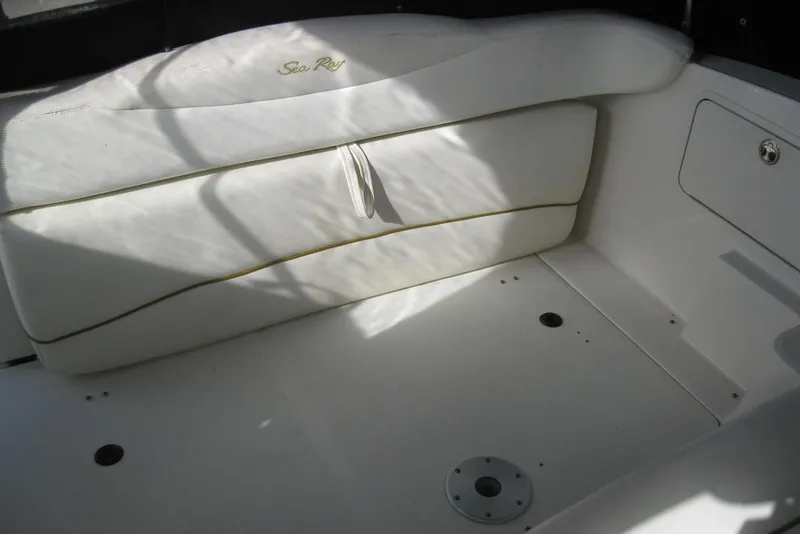 Slide: The Image of 2002 Sea Ray Sundancer 280 interior with white seating and storage compartment. - 14