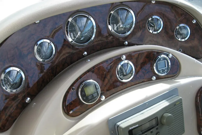 Slide: The Image of 2002 Sea Ray Sundancer 280 dashboard with steering wheel and control panel. - 18