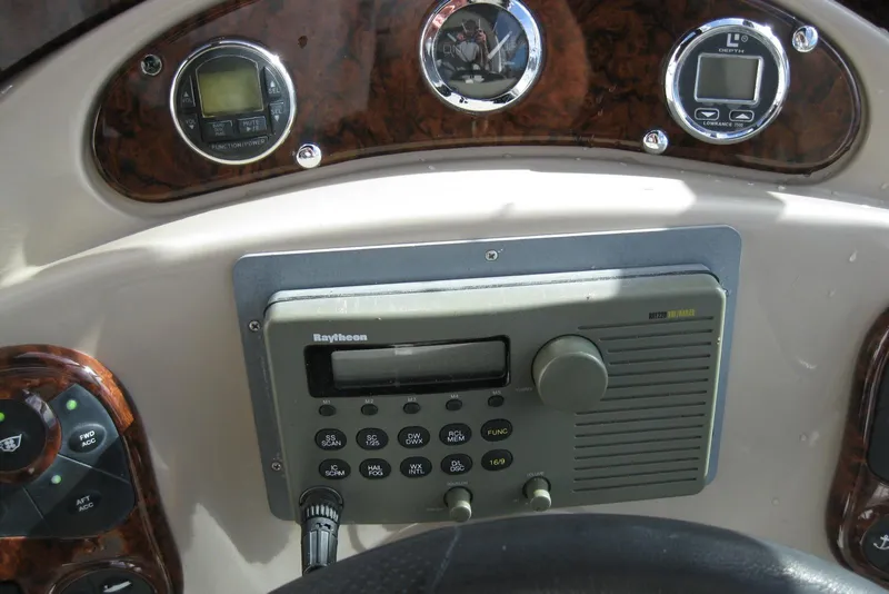 Slide: The Image of Control panel of a 2002 Sea Ray Sundancer 280 boat with various function buttons. - 21