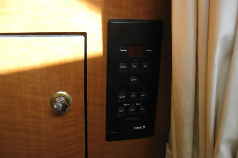 Slide: The Image of Interior of 2002 Sea Ray Sundancer 280, featuring wood cabinetry and cushioned seating. - 28