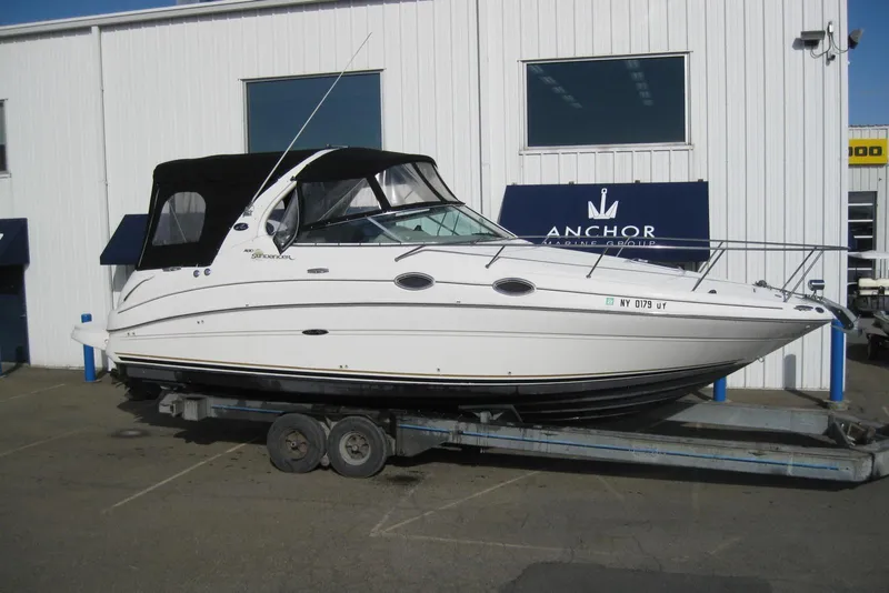 Slide: The Image of 2002 Sea Ray Sundancer 280 boat docked in calm waters. - 3