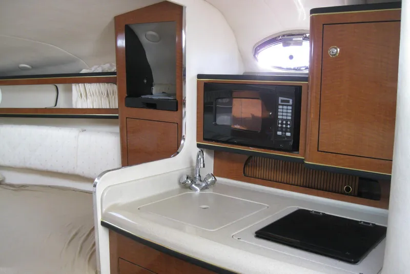 Slide: The Image of Control panel of a 2002 Sea Ray Sundancer 280 with switches and Clarion stereo system. - 32