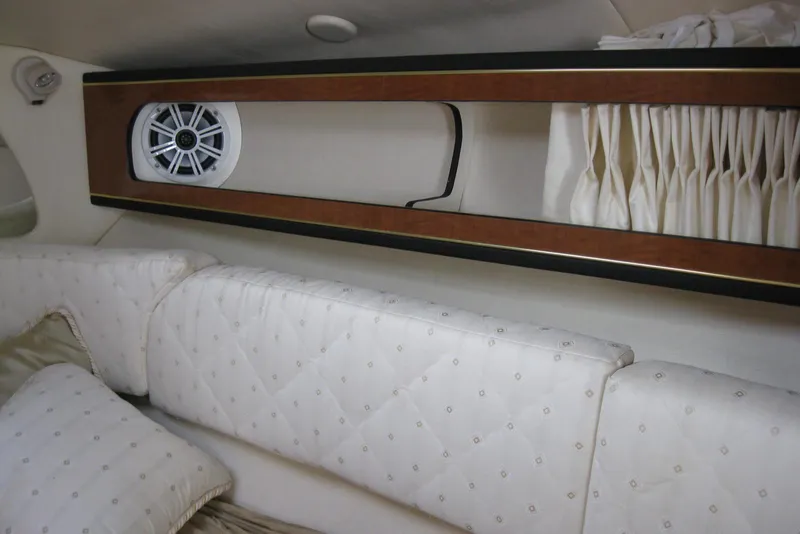 Slide: The Image of Interior cabin of 2002 Sea Ray Sundancer 280 with plush seating and pillows. - 35