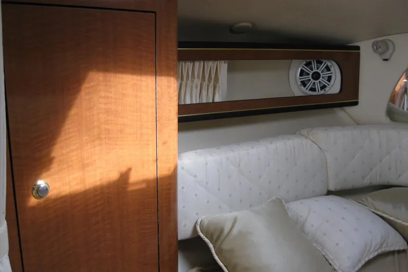 Slide: The Image of Interior of 2002 Sea Ray Sundancer 280 with cushioned seating and speaker. - 36