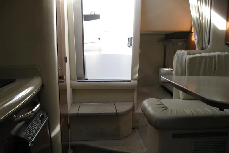 Slide: The Image of Interior of 2002 Sea Ray Sundancer 280 with wood paneling and cushioned seating. - 37