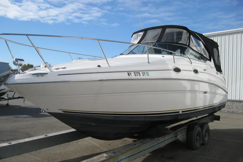 Slide: The Image of 2002 Sea Ray Sundancer 280 boat displayed outside a dealership. - 5