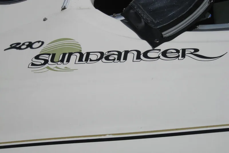 Slide: The Image of 2002 Sea Ray Sundancer 280 boat on trailer under clear blue sky. - 6