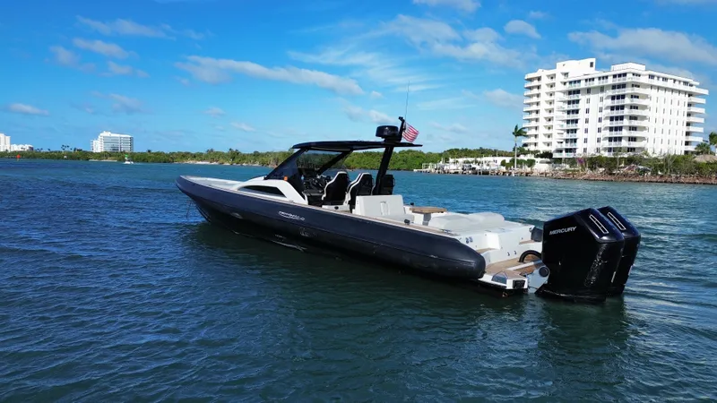 Slide: The Image of Technohull 47 Omega 2023 on calm water near buildings. - 10