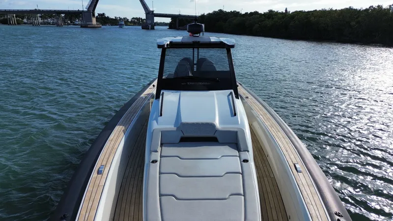 Slide: The Image of Technohull 47 Omega 2023 on calm water with bridge in background. - 13