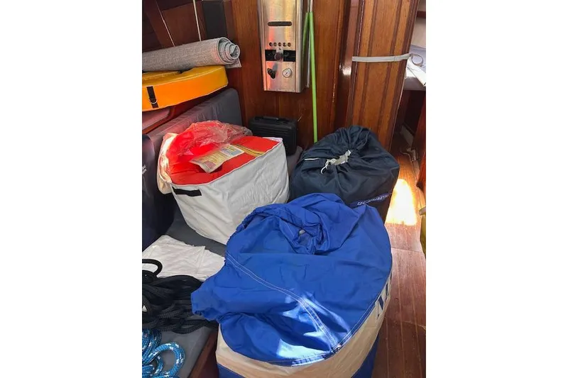 Slide: The Image of Interior of 1982 Ericson 33 sailboat with gear bags and equipment. - 11