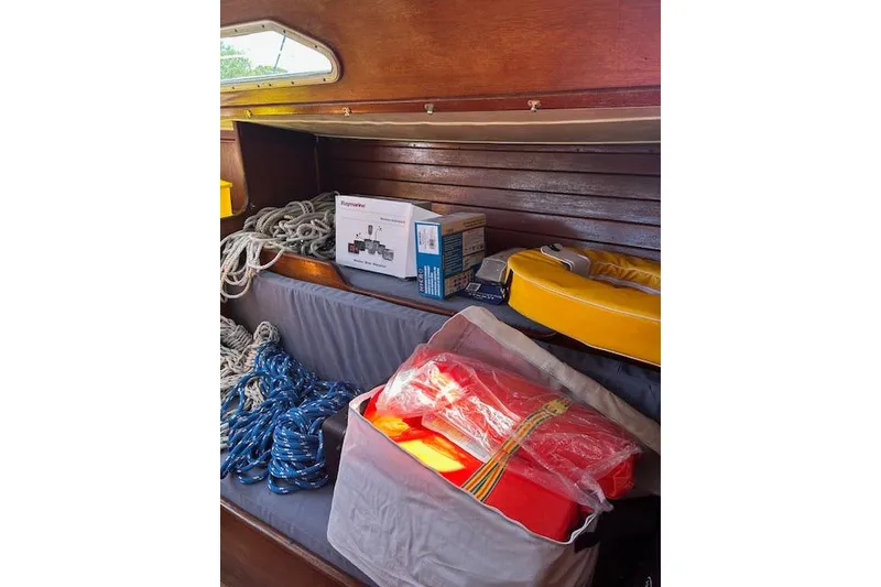 Slide: The Image of Interior of 1982 Ericson 33 sailboat with ropes, life jackets, and equipment. - 12
