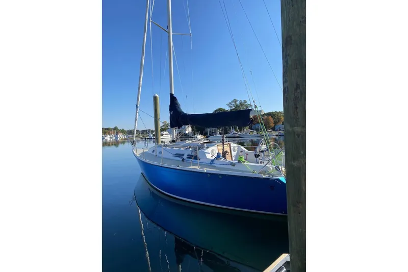Slide: The Image of Blue 1982 Ericson 33 sailboat docked in calm marina waters. - 21