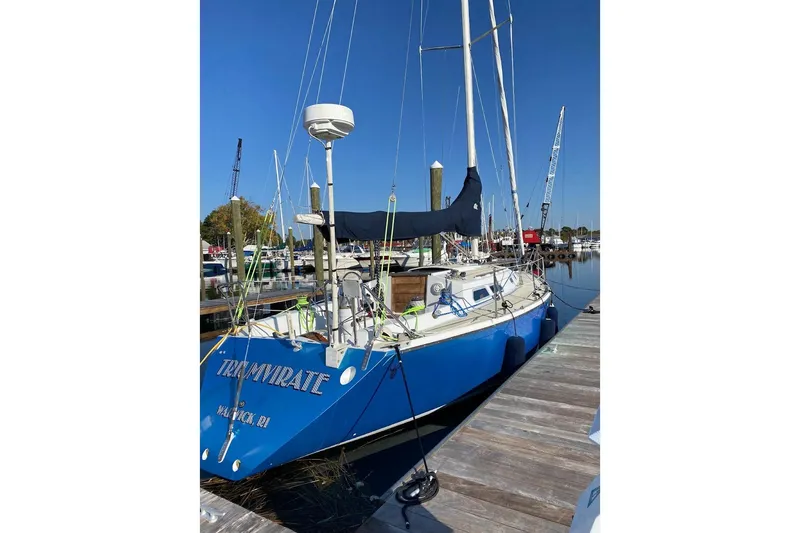 Slide: The Image of 1982 Ericson 33 sailboat docked, blue hull, clear sky, marina background. - 22