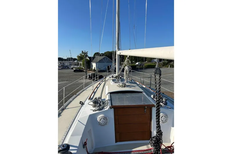Slide: The Image of 1982 Ericson 33 sailboat deck view with clear blue sky background. - 3