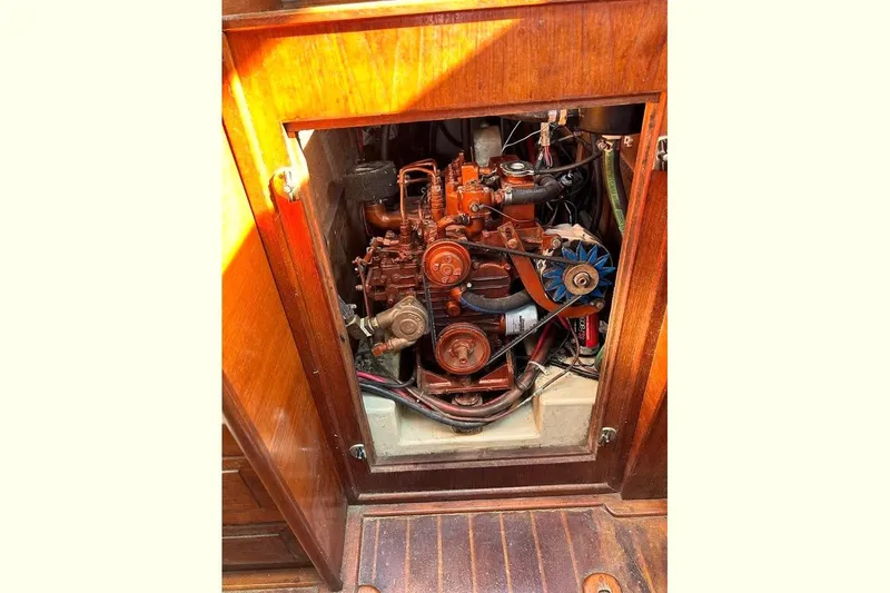 Slide: The Image of Engine compartment of a 1982 Ericson 33 sailboat, showcasing mechanical components. - 6