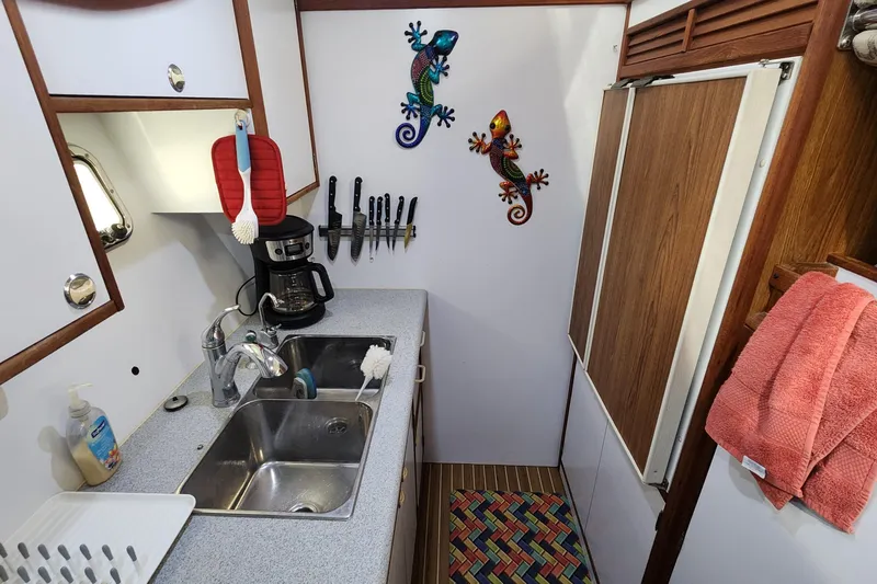 Slide: The Image of Compact kitchen in 2005 Endeavour 44 TrawlerCat with sink, coffee maker, and colorful decor. - 11