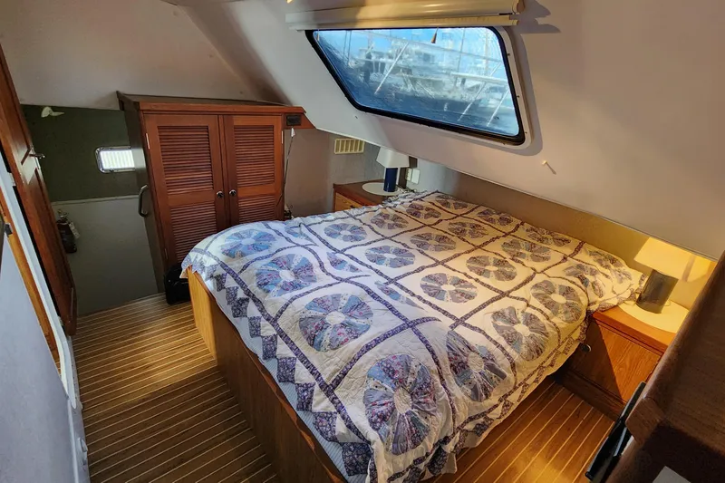 Slide: The Image of Cozy bedroom in 2005 Endeavour 44 TrawlerCat with quilted bedspread and wooden cabinetry. - 13