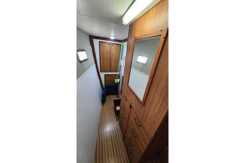 Slide: The Image of Interior of 2005 Endeavour 44 TrawlerCat with wood paneling and storage cabinets. - 14