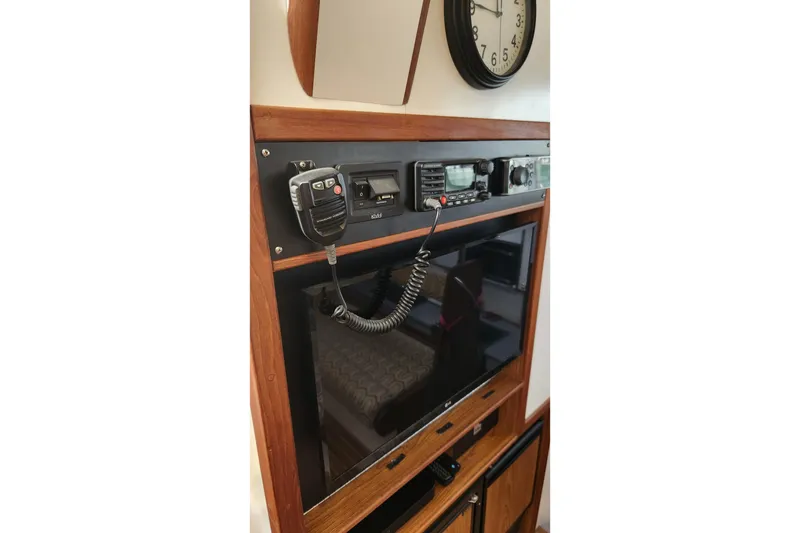 Slide: The Image of 2005 Endeavour 44 TrawlerCat interior with radio equipment and wall clock. - 22