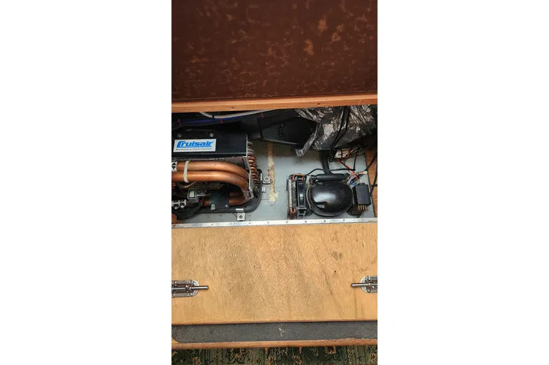 Slide: The Image of Engine compartment of a 2005 Endeavour 44 TrawlerCat with visible components and wiring. - 24