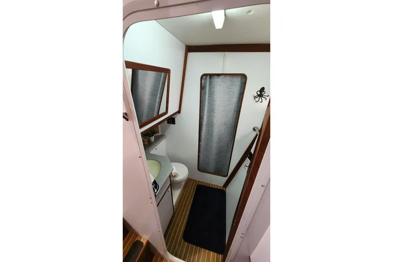 Slide: The Image of Bathroom interior of 2005 Endeavour 44 TrawlerCat with wood accents and nautical decor. - 25
