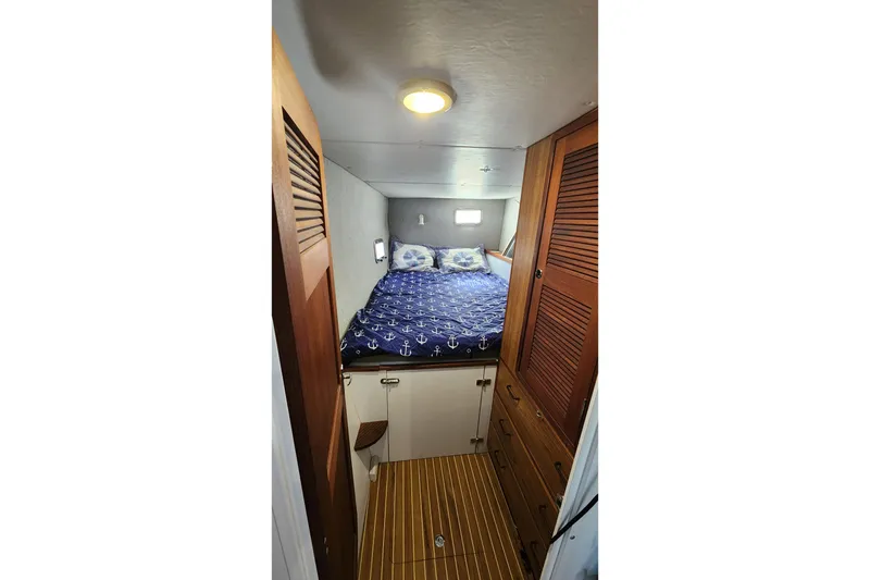 Slide: The Image of Cozy cabin interior of 2005 Endeavour 44 TrawlerCat with nautical-themed bedding. - 28