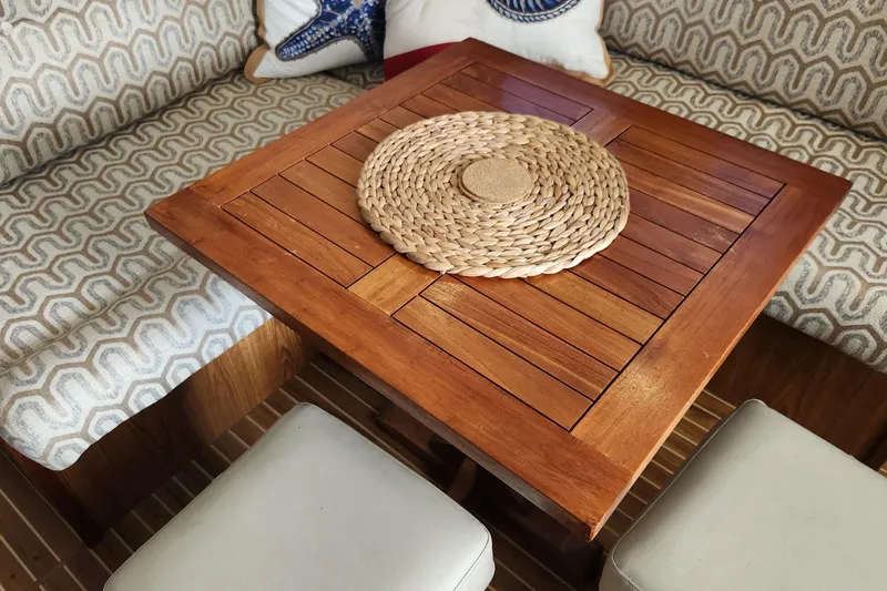 Slide: The Image of Cozy interior of 2005 Endeavour 44 TrawlerCat with wooden table and patterned seating. - 3