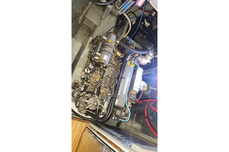 Slide: The Image of Engine compartment of 2005 Endeavour 44 TrawlerCat, showcasing Yanmar marine engine. - 32