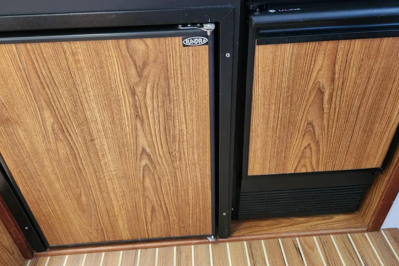Slide: The Image of Wood-paneled refrigerator doors on a 2005 Endeavour 44 TrawlerCat boat. - 36