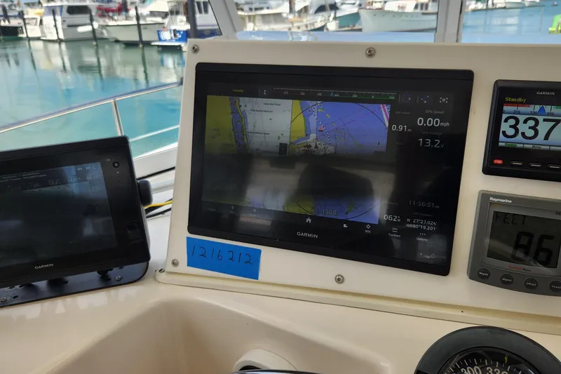 Slide: The Image of Navigation equipment on a 2005 Endeavour 44 TrawlerCat, docked at a marina. - 37