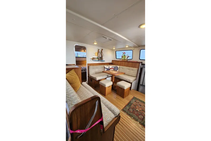 Slide: The Image of Interior of 2005 Endeavour 44 TrawlerCat with cozy seating and wooden accents. - 4