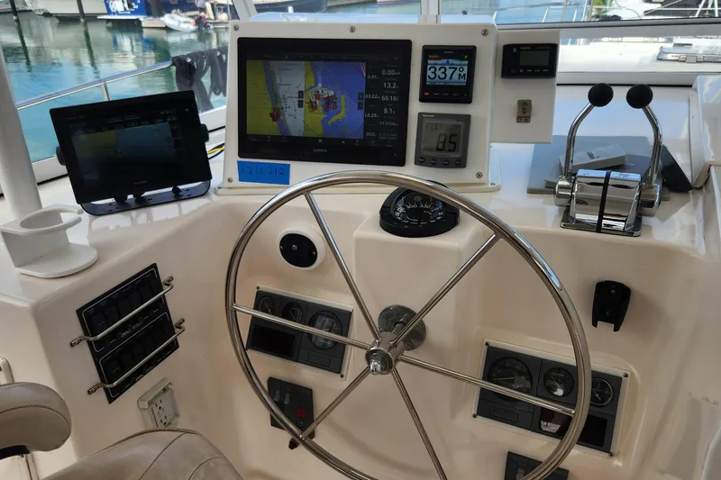 Slide: The Image of Helm of 2005 Endeavour 44 TrawlerCat with navigation screens and controls. - 41