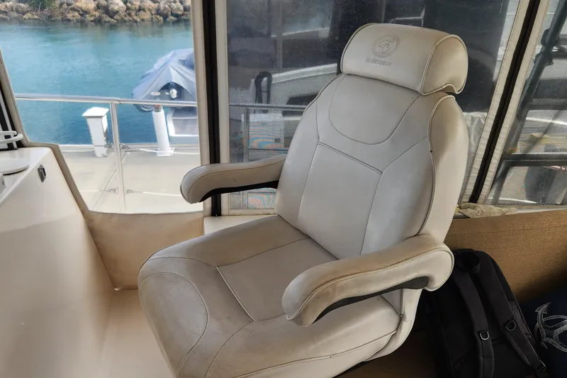 Slide: The Image of Captain's chair on 2005 Endeavour 44 TrawlerCat, overlooking serene water view. - 42