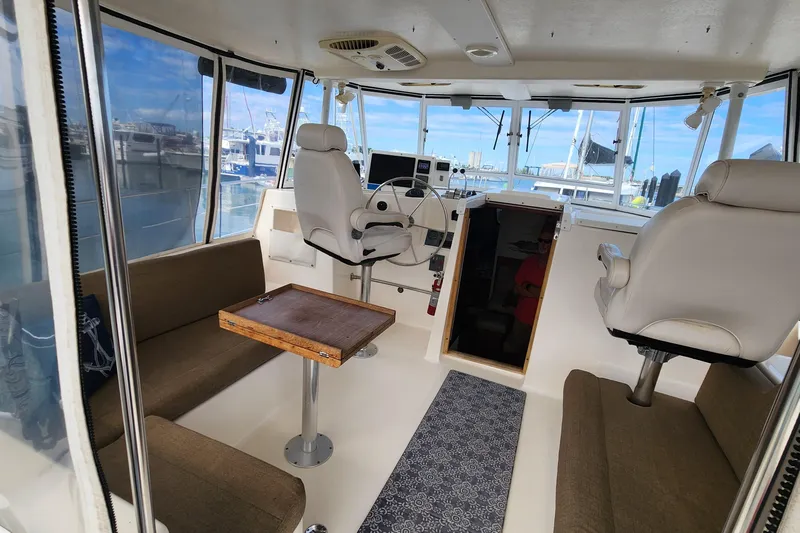 Slide: The Image of Interior of 2005 Endeavour 44 TrawlerCat with helm, seating, and table. - 44
