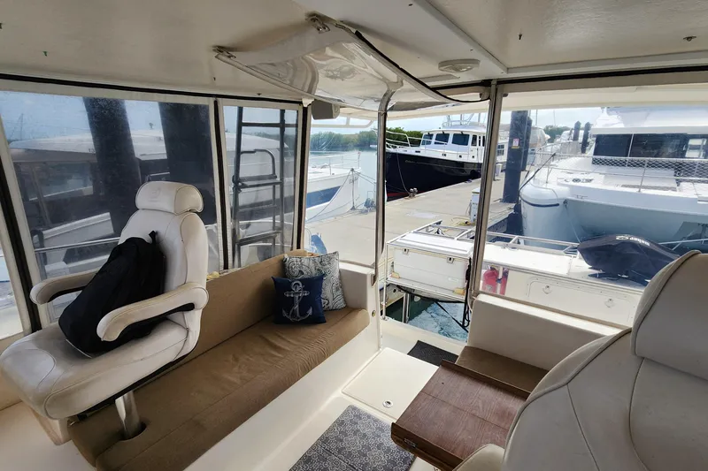 Slide: The Image of Interior of 2005 Endeavour 44 TrawlerCat with seating, nautical decor, and marina view. - 48