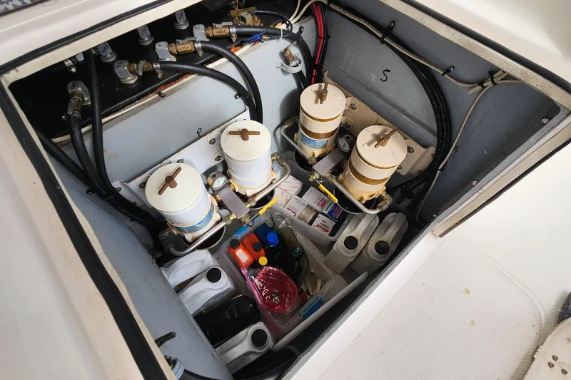 Slide: The Image of Engine compartment of a 2005 Endeavour 44 TrawlerCat with filters and maintenance supplies. - 49