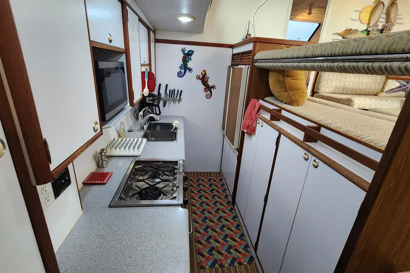 Slide: The Image of Compact kitchen in 2005 Endeavour 44 TrawlerCat with stove, sink, and cozy decor. - 5