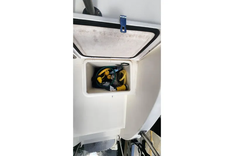 Slide: The Image of Storage compartment on a 2005 Endeavour 44 TrawlerCat, containing coiled cables. - 52
