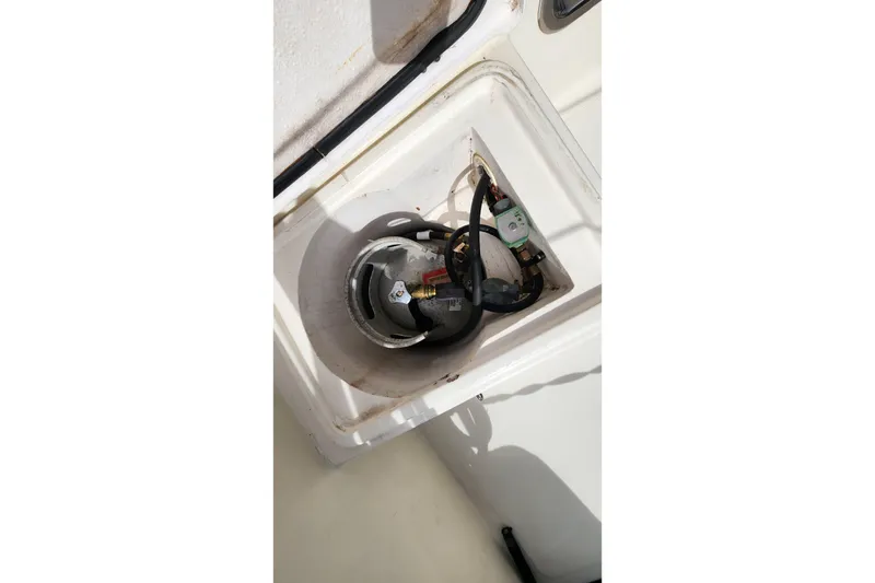 Slide: The Image of Storage compartment on 2005 Endeavour 44 TrawlerCat, featuring a propane tank and hoses. - 54